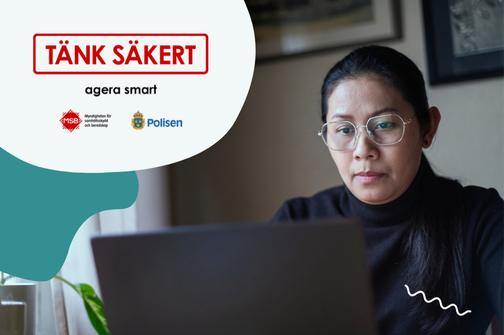 En person sitter vid ett fönster och arbetar koncentrerat vid en laptop.